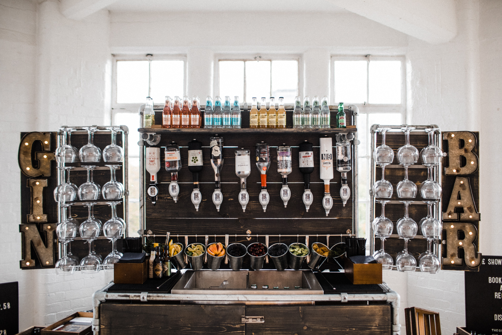 Rustic gin bar stocked with bottles and glasses