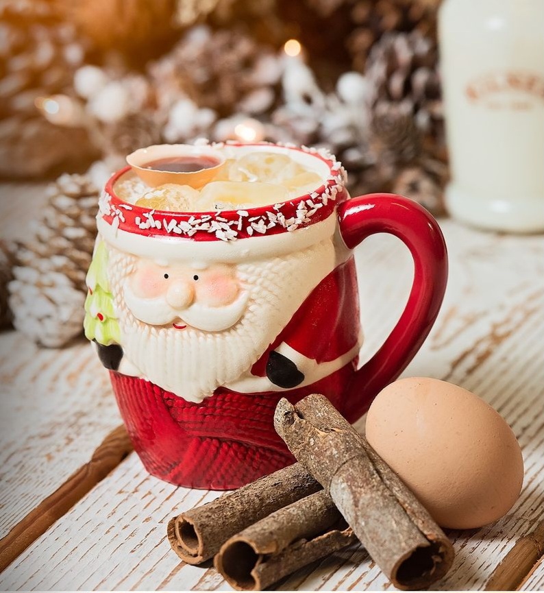 Serve Eggnoggins Chrristmas cocktails in Santa nugs with a pile of cinnamon sticks and an uncracked egg